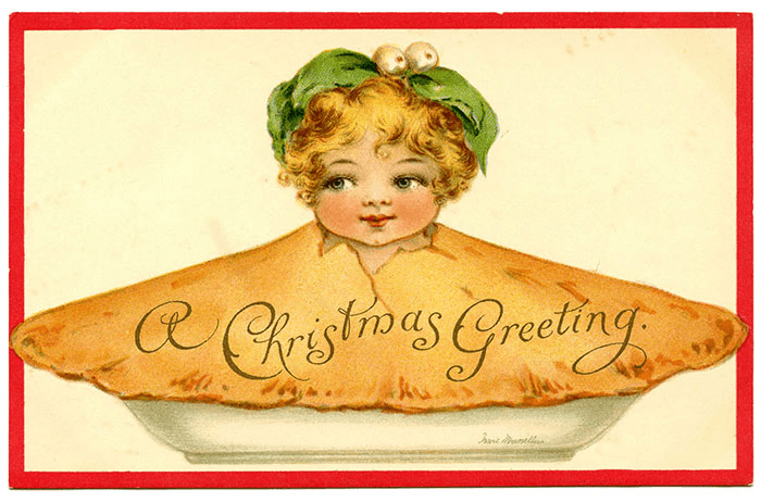 A large pie crust with a cherubic child's head bursting up through the centre of the pastry. On the pasty reads "a christmas greeting"